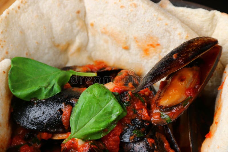 Pizza with Mussels on Table Restaurant Traditional Pizza with Basil