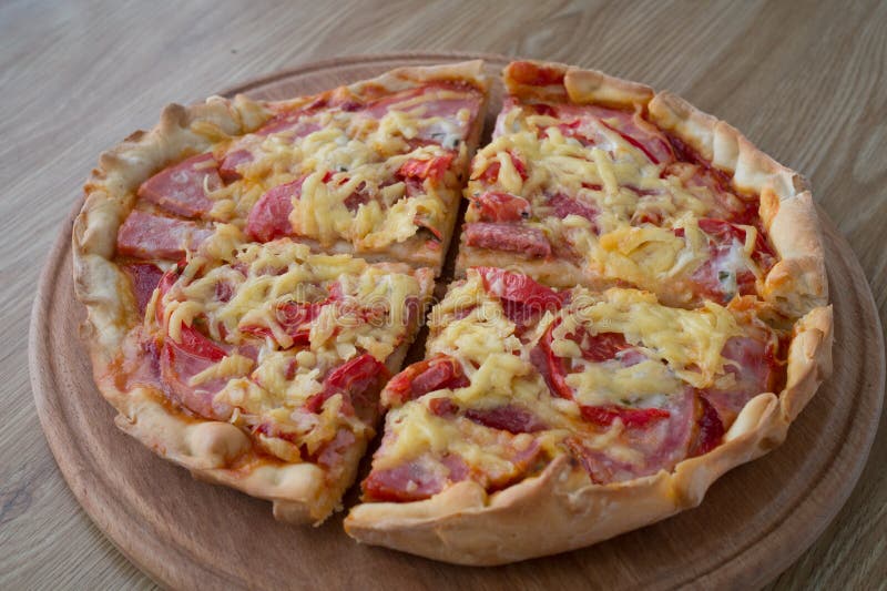 Average sizes a pizza lie in the portions on a round board. Average sizes a pizza lie in the portions on a round board
