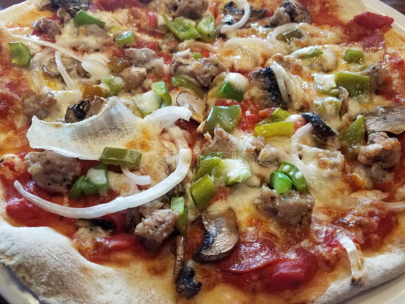 Pizza with Pepperoni, Sausage, Onion, and Green Peppers Stock Image