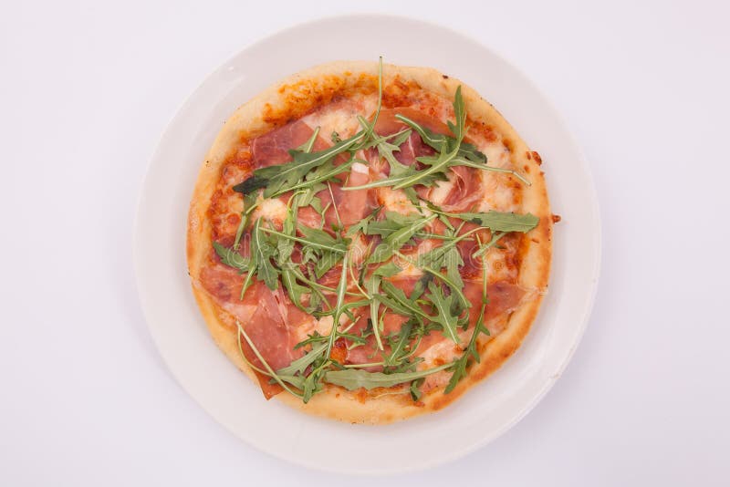 Pizza with Prosciutto Parma Ham and Arugula Salad Rocket Stock Image