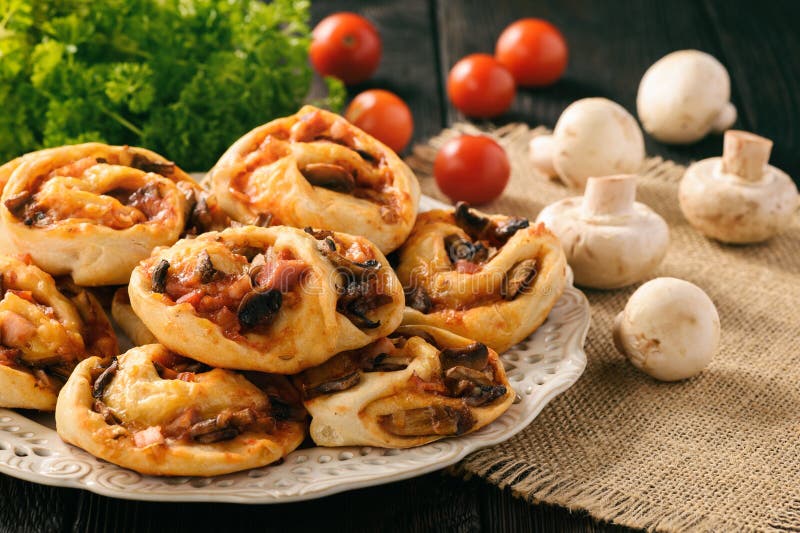 Pizza Rolls with Tomato Sauce, Bacon, Mushrooms and Cheese. Stock Image