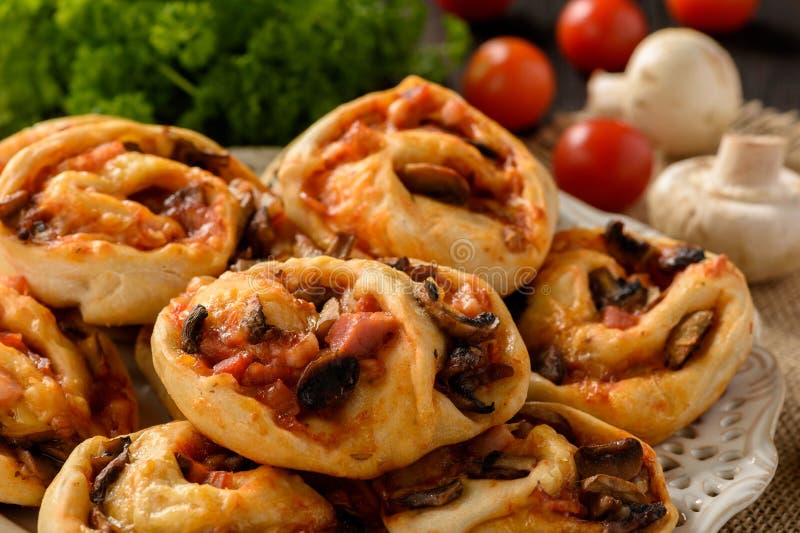 Pizza Rolls with Tomato Sauce, Bacon, Mushrooms and Cheese. Stock Image