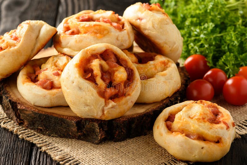 Pizza Rolls with Tomato Sauce, Bacon, Mushrooms and Cheese. Stock Image