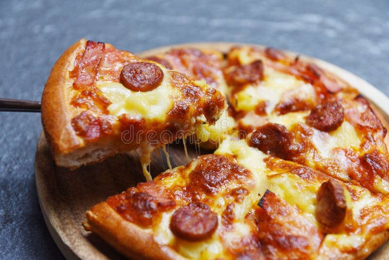 Pizza slice on dark background / delicious tasty fast food italian traditional pizza cheese stock photo Pizza slice on dark background / delicious tasty fast food italian traditional pizza cheese stock photo