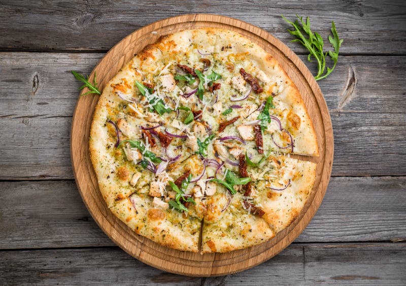 Pizza with Sundried Tomatoes, Prosciutto, Arugula and Parmesan Cheese