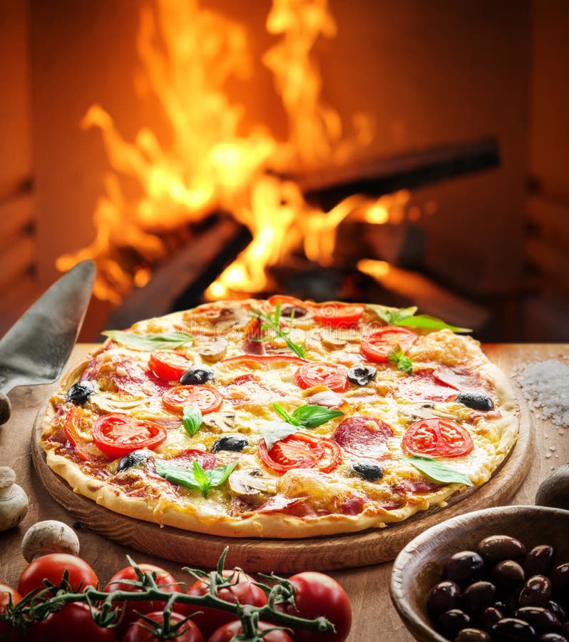 Pizza. Wood-fired oven on the background. Pizza. Wood-fired oven on the background.