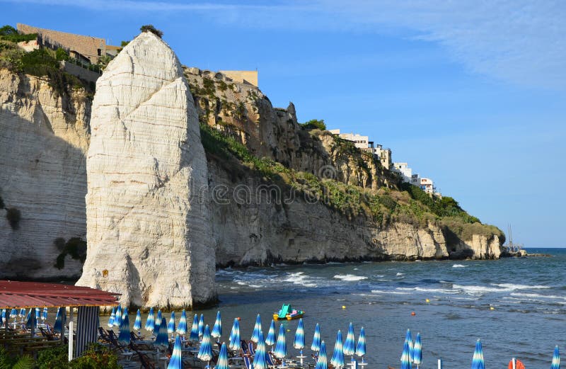 Pizzomunno - a vertical rocky monolith in Vieste town. Vieste's most famous point. Pizzomunno - a vertical rocky monolith in Vieste town. Vieste's most famous point.