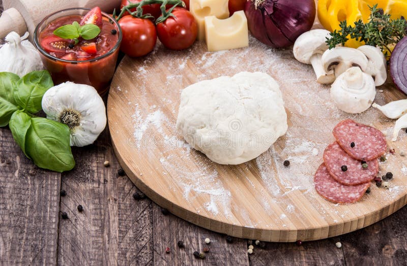 Homemade pizza dough on wooden background. Homemade pizza dough on wooden background