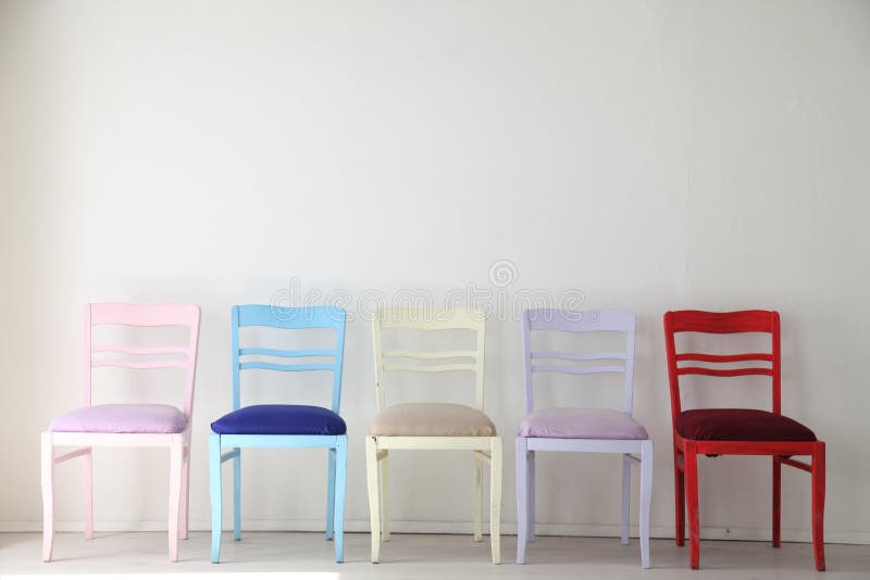 White room with colorful chairs blue yellow red blue purple pink. White room with colorful chairs blue yellow red blue purple pink