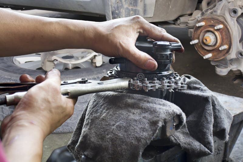 Car mechanic fixing parts of automobile at repair service station. Car mechanic fixing parts of automobile at repair service station