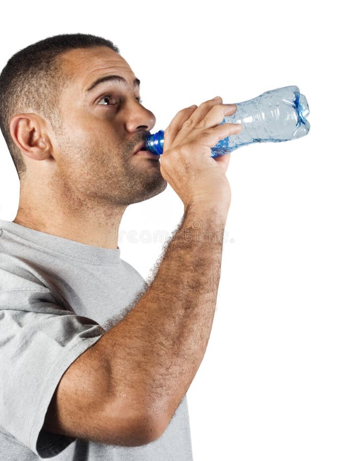 Thirsty young man drinking water from a plastic bottle. Thirsty young man drinking water from a plastic bottle