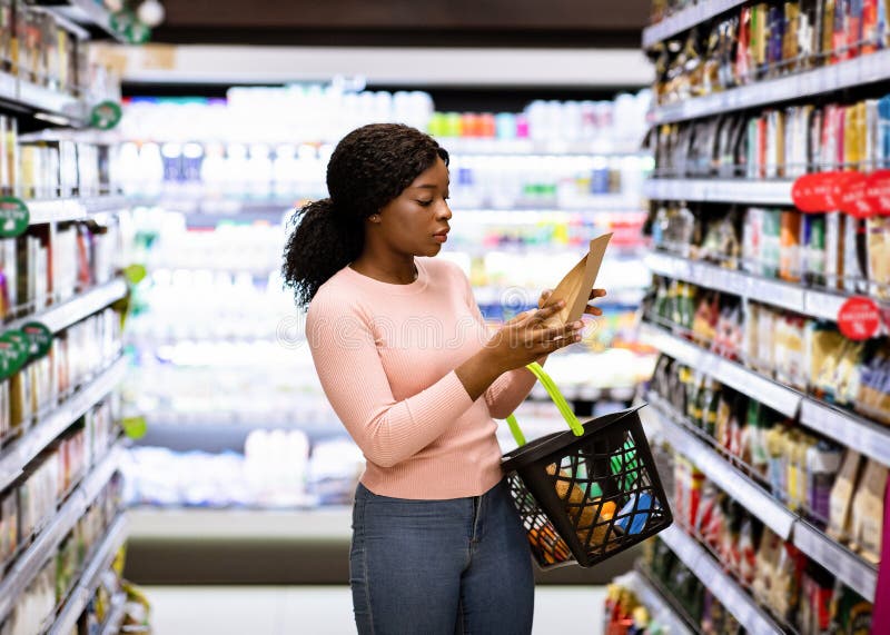 Piękna amerykańska kobieta, wybierająca produkty w supermarkecie