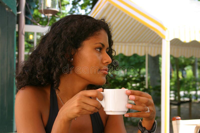 Beautiful brazilian woman drinking a cup of coffee. Beautiful brazilian woman drinking a cup of coffee