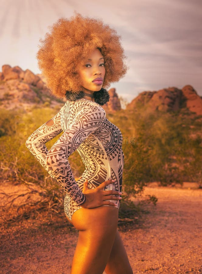 Beautiful African American woman standing proudly in wild desert location. Beautiful African American woman standing proudly in wild desert location