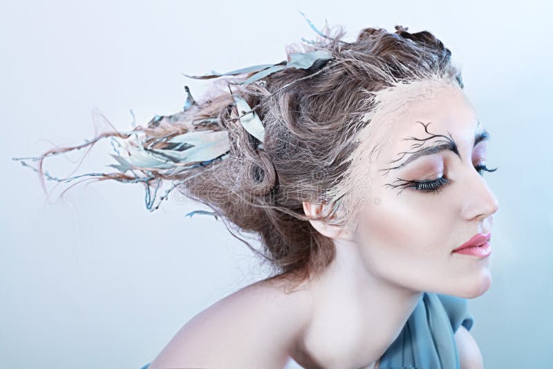 Beatiful high fasion female model with fantasy hair style and art make up nature concept. Beatiful high fasion female model with fantasy hair style and art make up nature concept