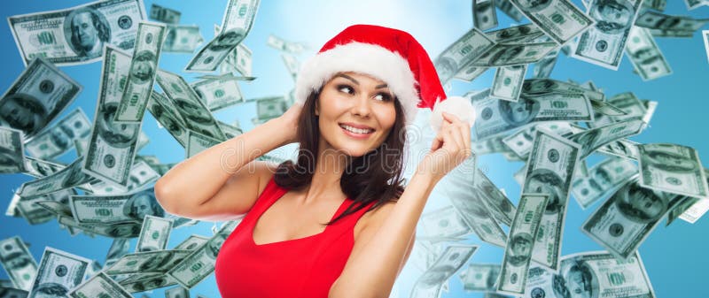 Piękna seksowna kobieta w Santa kapeluszu nad pieniądze deszczem zdjęcie royalty free Piękna seksowna kobieta w Santa kapeluszu nad pieniądze deszczem zdjęcie royalty free