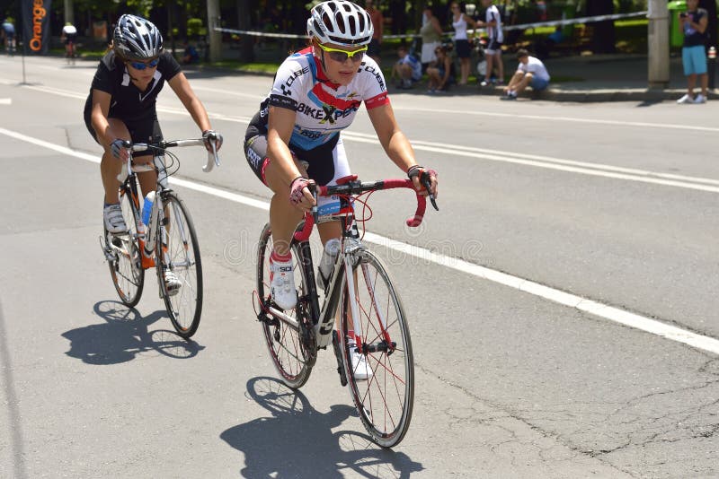 Piękne kobiety jedzie bicykle w słonecznym dniu, współzawodniczy dla Drogowego Uroczystego Prix wydarzenia, szybkościowego obwodu fotografia stock Piękne kobiety jedzie bicykle w słonecznym dniu, współzawodniczy dla Drogowego Uroczystego Prix wydarzenia, szybkościowego obwodu fotografia stock