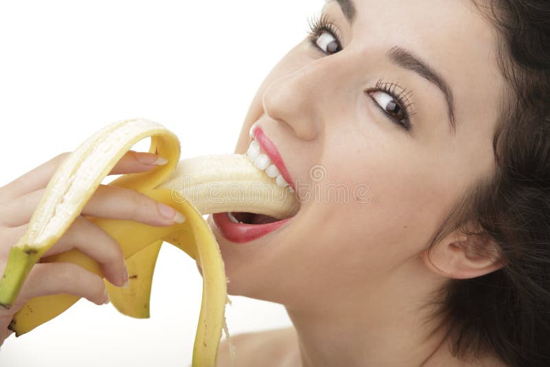 Piękny kobiety łasowania banan obraz stock Piękny kobiety łasowania banan obraz stock