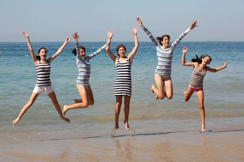 Five teenage girls jumping on the beach. Five teenage girls jumping on the beach