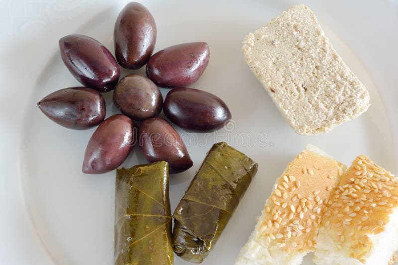 Fasting food concept of plate with olives, dolma, halva and lagana. Fasting food concept of plate with olives, dolma, halva and lagana