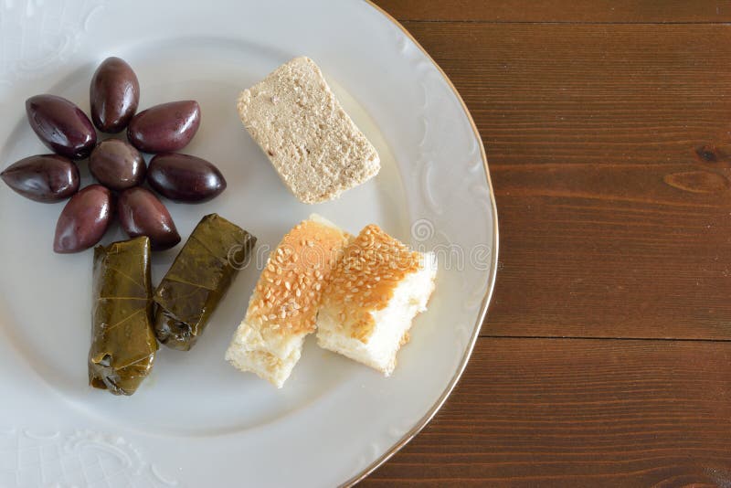 Fasting food concept of plate with olives, dolma, halva and lagana. Fasting food concept of plate with olives, dolma, halva and lagana