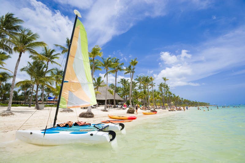 Sailboat moored at shore of tropical Bavaro beach in Sargasso sea, Punta Cana, Dominican Republic. Sailboat moored at shore of tropical Bavaro beach in Sargasso sea, Punta Cana, Dominican Republic