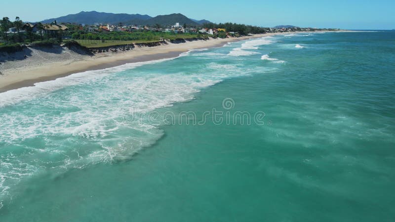Plage de sable avec vagues au brésil. vue aérienne de la plage de campeche florianopolis banque de vidéos
