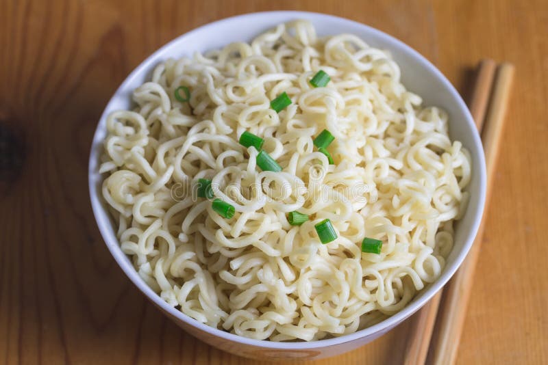 Bowl of Instant Cooked Plain Noodles with Chopsticks and Pepper Stock