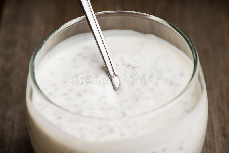 Plain Yogurt with Chia Seeds in Glass on the Rustic Wooden Background