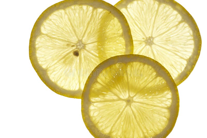 Three back lit cross sections of sliced lemon, isolated on white background. Three back lit cross sections of sliced lemon, isolated on white background.