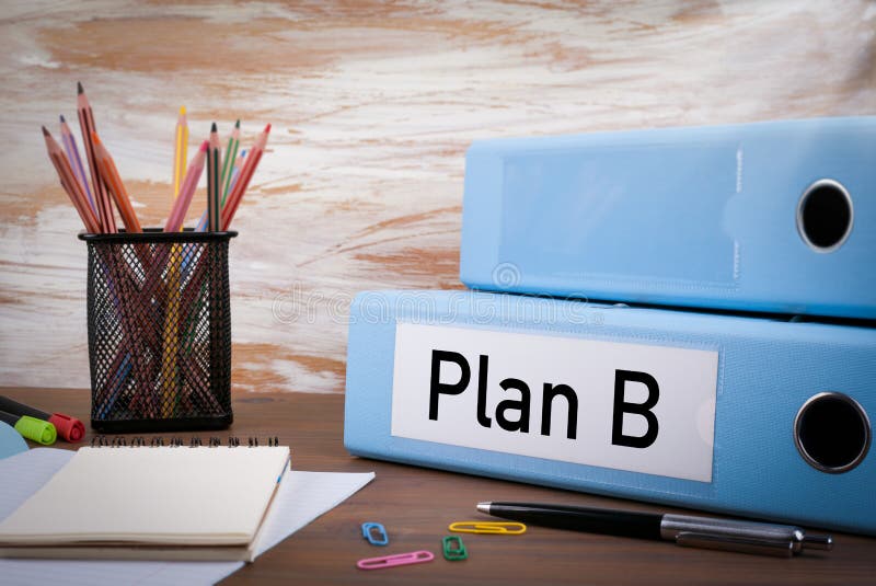 Plan B, Office Binder on Wooden Desk. On the table colored pencils, pen, notebook paper