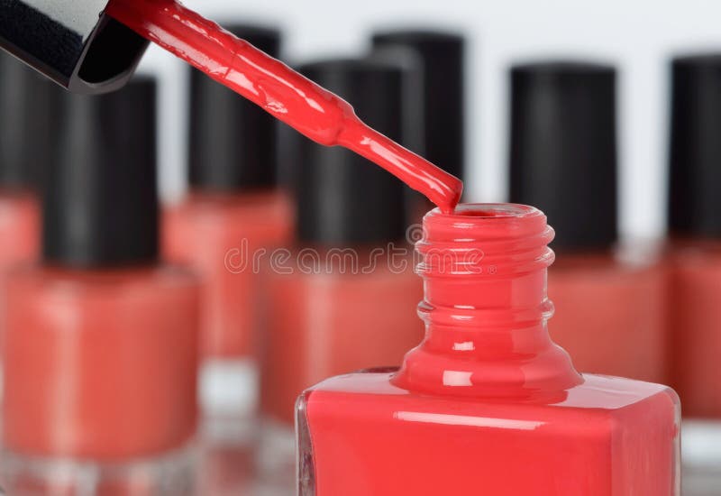Close-up of a bottle of red nail polish with other bottles in background. Close-up of a bottle of red nail polish with other bottles in background