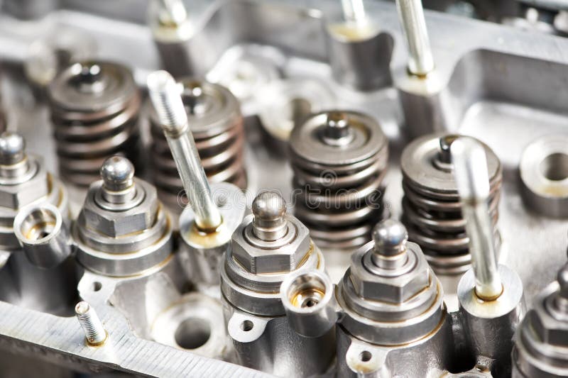 Close-up of opened automobile engine cylinder head for maintenance repair at car service station. Close-up of opened automobile engine cylinder head for maintenance repair at car service station