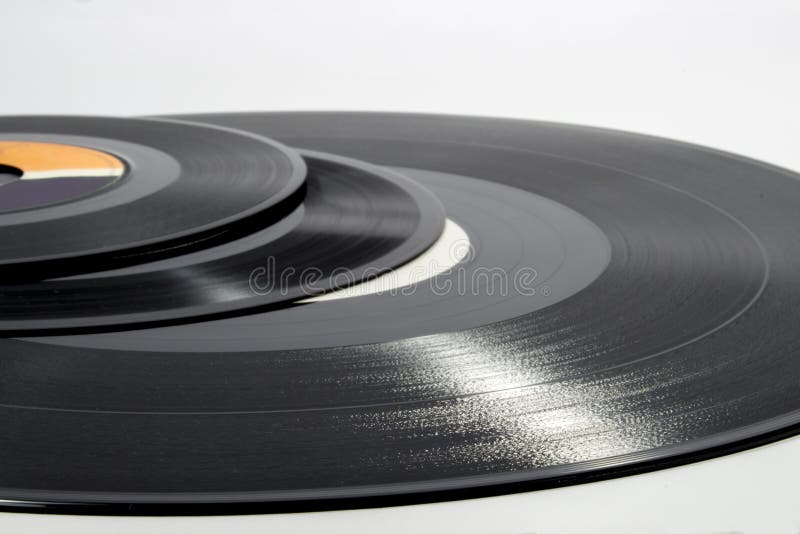 Several vinyl records of different sizes on white background. Several vinyl records of different sizes on white background