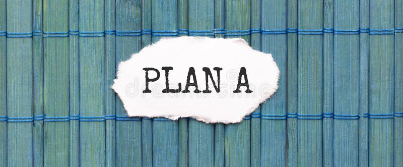 PLAN A text on the piece of paper on the green wood background stock photo