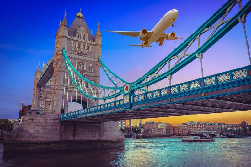 Plane Flying Above Tower Bridge at Sunset in London Stock Photo - Image