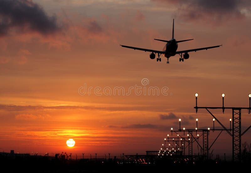 Plane landing in a sunset stock image. Image of commercial 28132353
