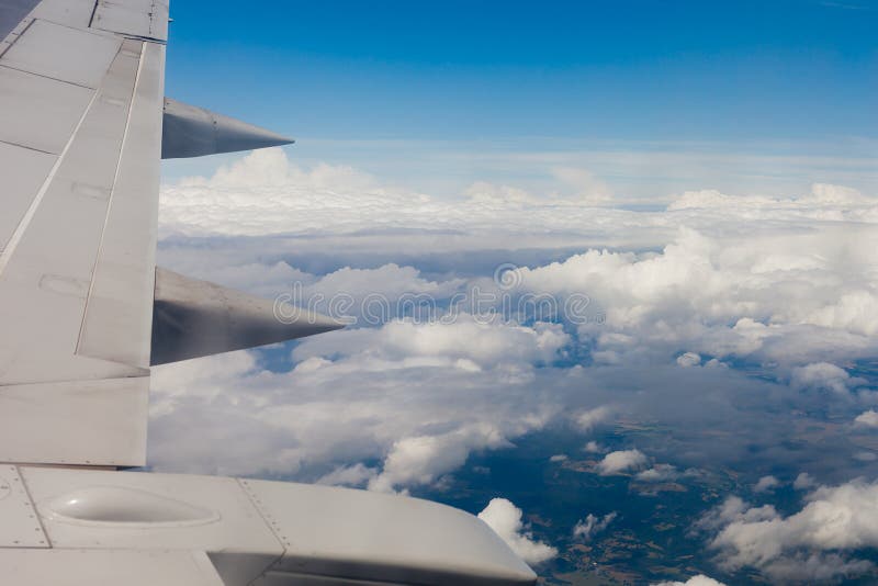 Plane wing, ground, clouds and sky stock photography
