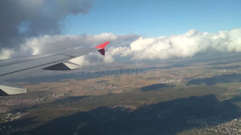 Plane wing, land surface and clouds at decrease. Frankfurt am Main, Germany; 2018-11-02. Decrease video