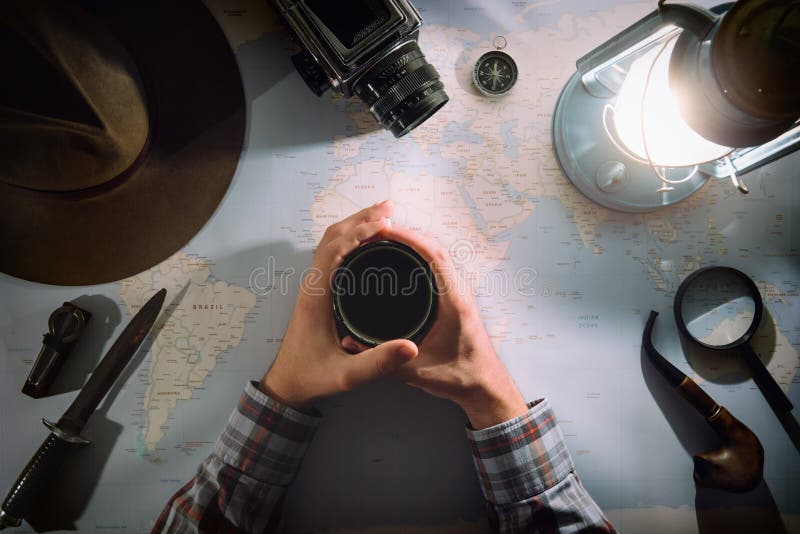 Planeamiento de la aventura cerca de la endecha plana de la lámpara de gas Engranaje viejo atmosférico en mapa Viajero, manos del foto de archivo libre de regalías Planeamiento de la aventura cerca de la endecha plana de la lámpara de gas Engranaje viejo atmosférico en mapa Viajero, manos del foto de archivo libre de regalías