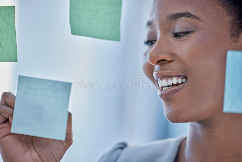 Planning, brainstorming and black woman writing a schedule on a sticky note, agenda or a work goal. Research, creative