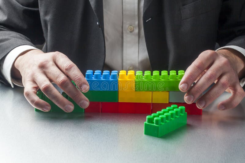 Planning construction with plastic toys at work royalty free stock photography Planning construction with plastic toys at work royalty free stock photography