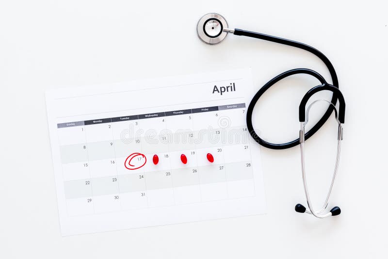 Planning medical examination concept. Regular medical examinations. Calendar with date circled, pills and stethoscope on stock image Planning medical examination concept. Regular medical examinations. Calendar with date circled, pills and stethoscope on stock image