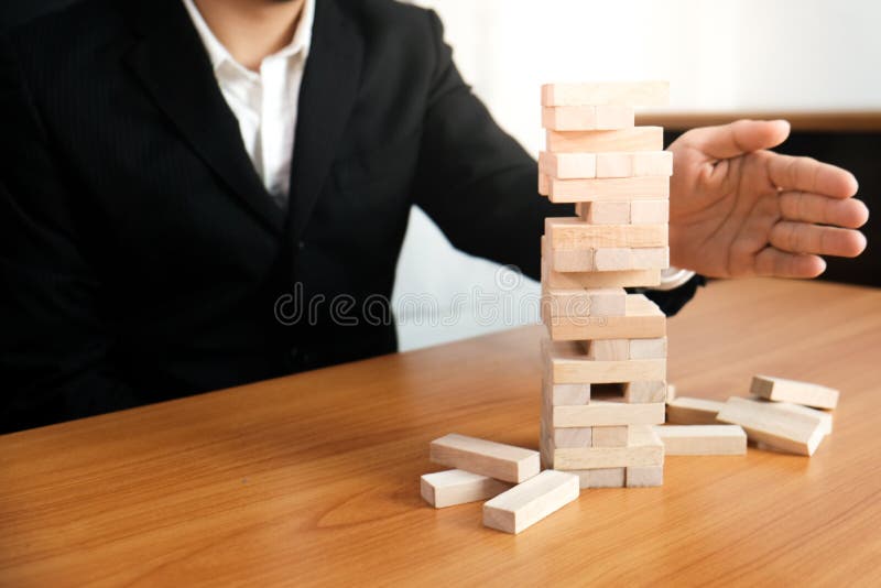 Planning risk and strategy in businessman gambling placing wooden block.Business concept for growth success process royalty free stock images Planning risk and strategy in businessman gambling placing wooden block.Business concept for growth success process royalty free stock images