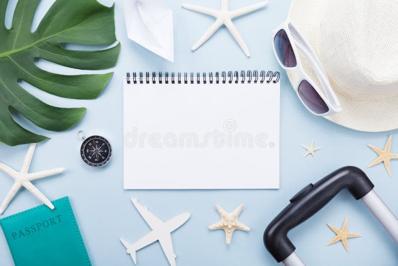 Planning summer holidays, vacations and trip. Travelers notebook with tourism accessories on blue table top view. Flat lay. stock images Planning summer holidays, vacations and trip. Travelers notebook with tourism accessories on blue table top view. Flat lay. stock images
