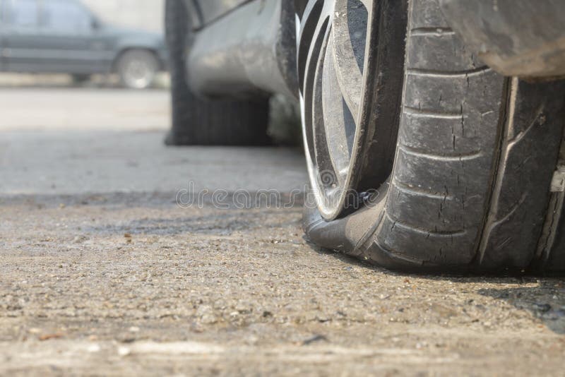 Car flat tire on concrete road. Car flat tire on concrete road