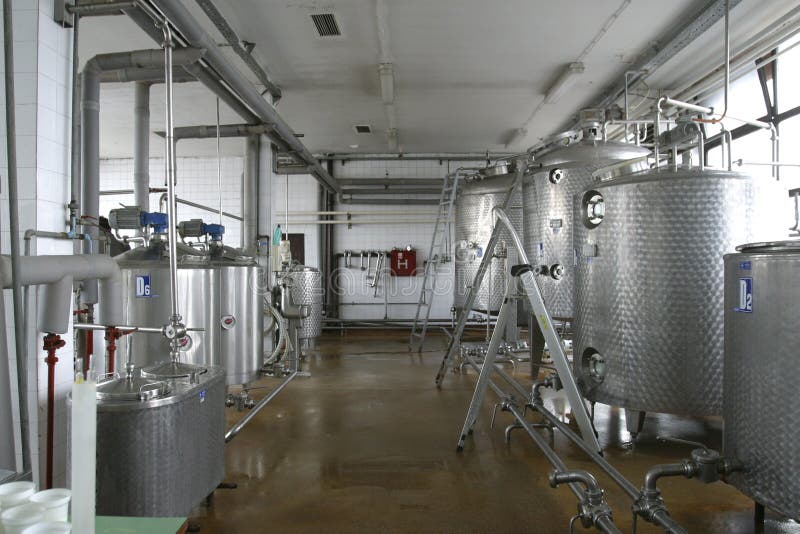 Stainless steel pipes and tanks in dairy food production plant. Stainless steel pipes and tanks in dairy food production plant