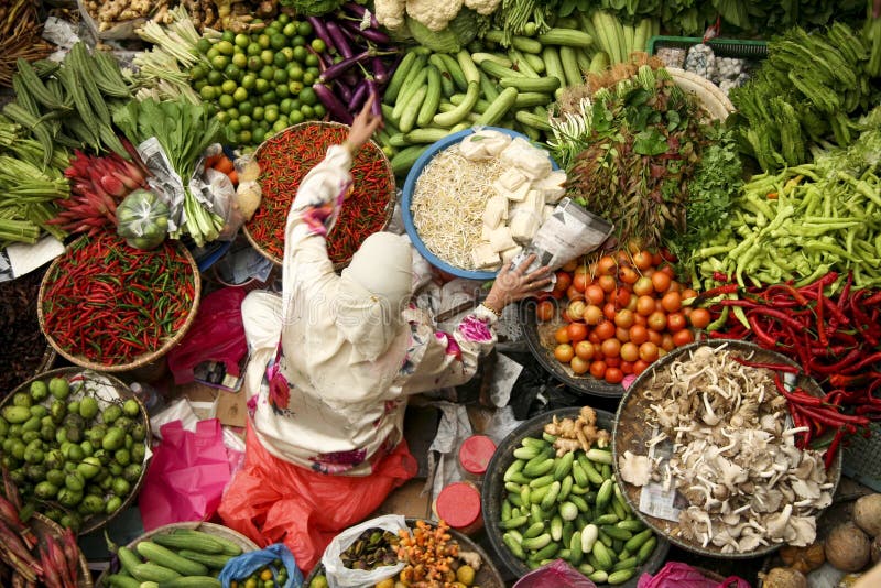 Muslim woman selling variety fresh vegetables at traditional fresh food market in kota baru malaysia. Muslim woman selling variety fresh vegetables at traditional fresh food market in kota baru malaysia