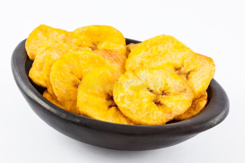 Plantain fried coins in a traditional black clay bowl royalty free stock photos Plantain fried coins in a traditional black clay bowl royalty free stock photos