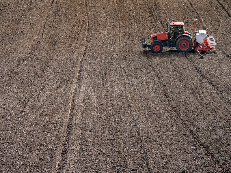 Planter sowing arable field with corn seeds royalty free stock images